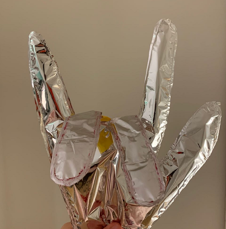 a hand gesture made with inflatable mylar